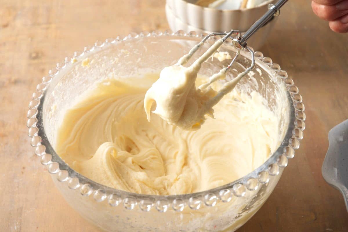 Cream cheese frosting in bowl with beater.