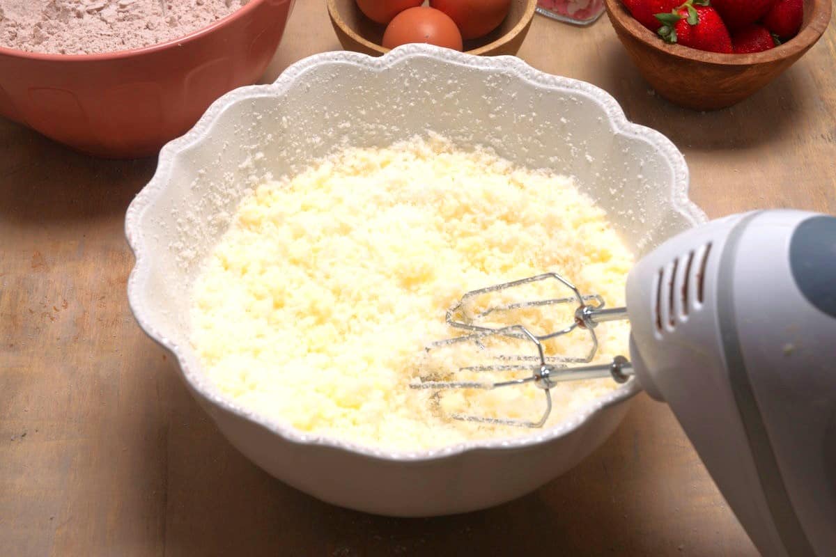 Butter and sugar in bowl with mixer.